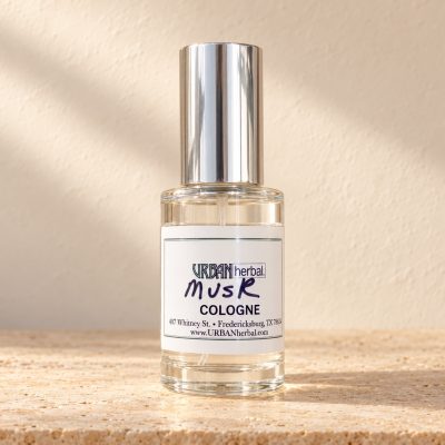 URBANherbal Musk cologne on warm ivory stone